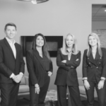 A group of people standing in an office